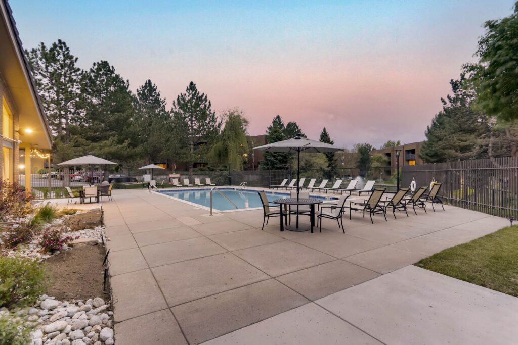 Pool with deck seating at Alta Springs apartments for rent in Denver