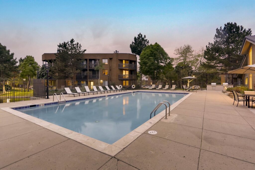 Pool with deck seating at Alta Springs renovated apartments in Denver