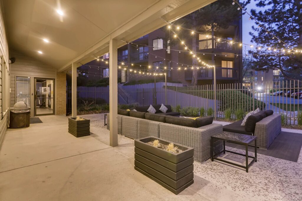 Clubhouse exterior with lounge seating under string lights