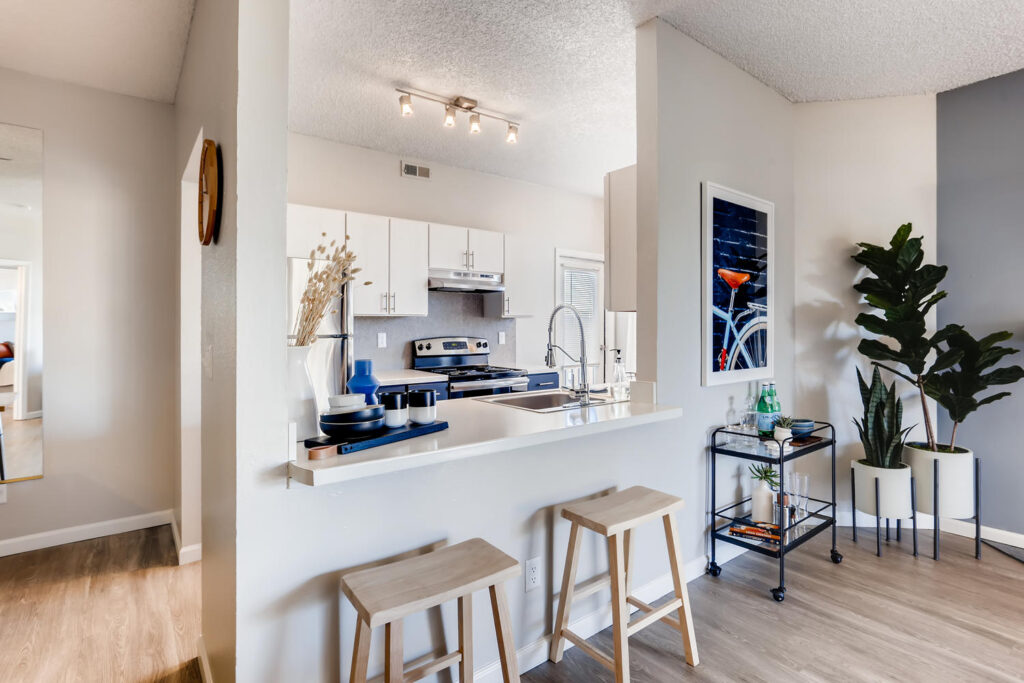 Kitchen with breakfast bar seating at Alta Springs Denver apartment complex