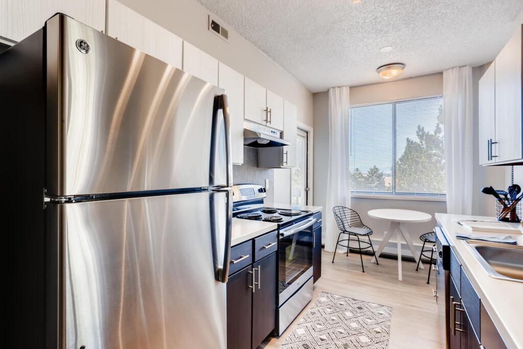 Kitchen with stainless steel appliances and tile backsplash